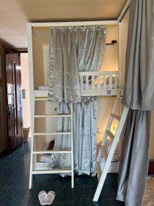 a bunk bed with two sets of bunk beds at Lay Low AC Hostel Nr Airport Ubon ที่พัก เลโล in Ubon Ratchathani +59 photos