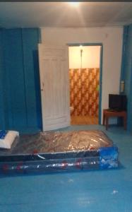 a bedroom with a bed with tin foil on it at Tanjong Tinggi Cottage in Sijuk