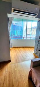 an empty living room with a hard wood floor at Studio La Amazon in Belém