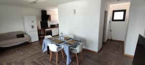 a living room with a table and chairs in a room at Villa la fournaise in Le Tampon