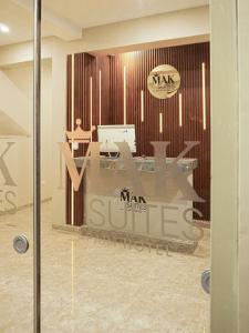 a glass door with a sign that says man sueses at Mak Suites in Piura