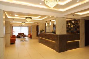 a lobby of a hotel with a reception counter and chairs at Vits Select Kharadi Pune in Pune