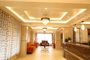 a lobby of a hotel with orange furniture at Vits Select Kharadi Pune in Pune