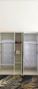 a white cabinet with empty shelves in a room at Camelia Youth City Nilai Studio residence 5pax in Nilai