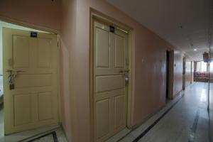 an empty hallway with two doors on the wall at SPOT ON Shraddha Hotel in Nagpur