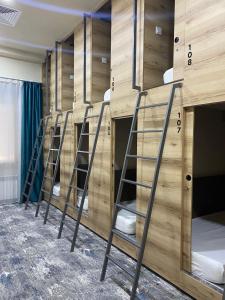 a row of bunk beds in a room at AQ Capsule Hostel in Almaty
