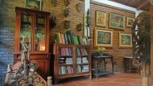 a room with a book shelf filled with books at Hills Joglo Villa in Ungaran