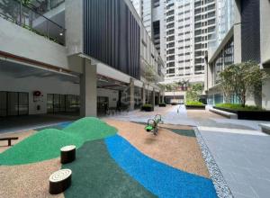 a large building with a green field in the middle at Camelia Youth City Nilai Studio residence 5pax in Nilai