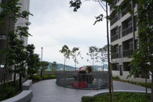 a woman sitting in a cage in a building at Camelia Youth City Nilai Studio residence 5pax in Nilai
