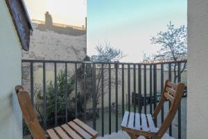 a pair of chairs sitting on a balcony at Elegant Apartment near to the Centre of Poznań by Rent like home in Poznań