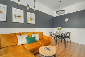 a living room with a couch and a table at Elegant Apartment near to the Centre of Poznań by Rent like home in Poznań