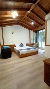a bedroom with a large bed in a room with wooden ceilings at Xitou Tianpin Homestay in Lugu