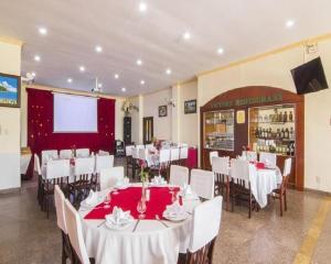 a dining room with white tables and white chairs at Victory Hotel Old Wing in Vung Tau