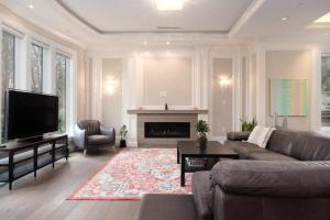 a living room with a couch and a fireplace at Dunbar Luxury Homestay in Vancouver