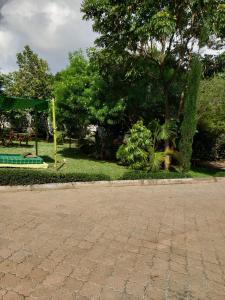 a park with a playground and a swing at Teresita Home in Nairobi