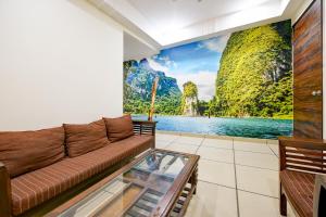 a living room with a couch and a mural of a lake at Empire inn Suites Hotel Near Delhi Airport in New Delhi