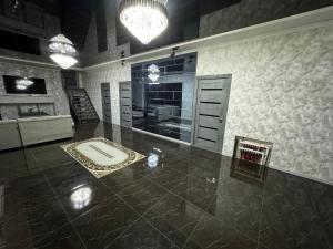 a bathroom with a large tile floor with a sink at “DACHA” Hi-Tech by Dubai in Aranchi