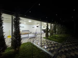 a room with a bench on a checkered floor at night at “DACHA” Hi-Tech by Dubai in Aranchi
