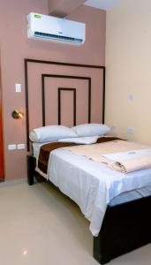 two beds in a room with avertisement for at Mak Suites in Piura