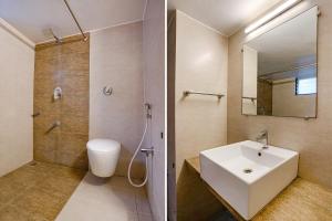 a bathroom with a sink and a shower and a toilet at FabHotel RVG, Alkapuri Vadodara in Vadodara