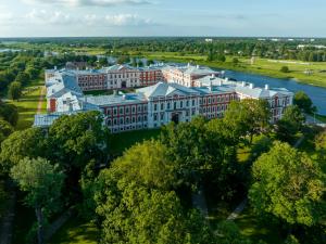 an aerial view of a large building next to a river at Hotel Jelgava in Jelgava