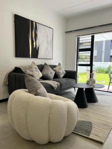 a living room with a couch and a table at Tocara Lifestyle Estate: Fourways in Johannesburg