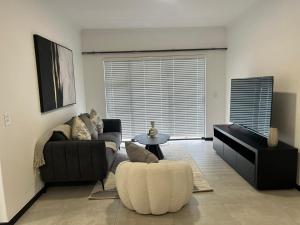 a living room with a couch and a table at Tocara Lifestyle Estate: Fourways in Johannesburg