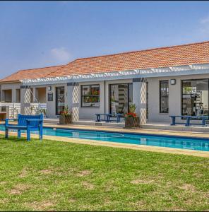 a house with a swimming pool next to a building at Tocara Lifestyle Estate: Fourways in Johannesburg