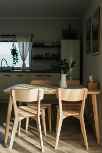 a kitchen with a wooden table and two chairs at Apartament ACTIV jezioro góry in Żywiec
