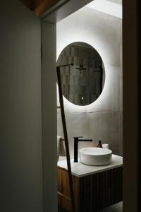 a bathroom with a sink and a mirror at Apartament ACTIV jezioro góry in Żywiec