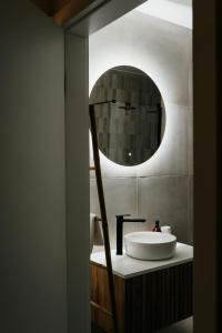 a bathroom with a sink and a mirror at Apartament ACTIV jezioro góry in Żywiec +40 photos
