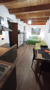 a kitchen and a living room with a green bed at Al Castello in Morano Calabro