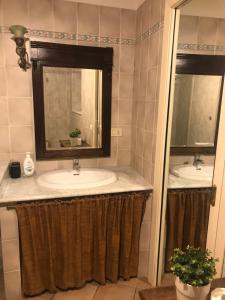 a bathroom with two sinks and a mirror at Numero 3 in Cagliari +21 photos