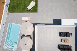 an aerial view of a swimming pool and umbrellas at Horizon Luxury Villa in Chania Town +43 photos