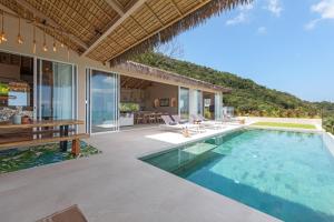 an outdoor patio with a swimming pool and a house at Bohemian Chic Seaview Villa in Koh Samui 
