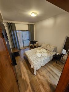 a bedroom with a bed and a table in it at VILLAGE SINTRA gh in Sintra