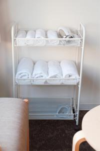 a towel rack with white towels on it at Tutulu502 in Osaka