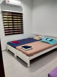 a bedroom with a large bed in a room at Annx 7 Melati Inn in Kajang