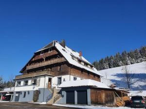 a large building with snow on top of it at Rinken 9 in Hinterzarten