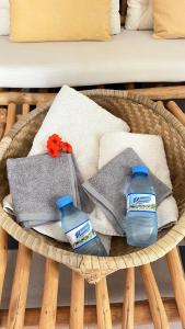 two bottles of water and towels in a basket at Keur Ama in Mbour