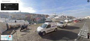a group of cars parked at a marina with boats at L'Ophelia Duplex Dernier étage balcon Centre climatisation in Sète