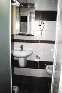 a bathroom with a sink and a toilet at Yeni Kosk Esra Hotel in Konya