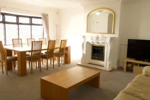 a living room with a table and a fireplace at Entire Private House In Chalkwell (Southend) Amazing Sea Views in Southend-on-Sea