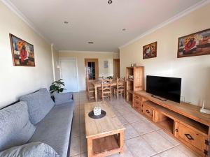 a living room with a couch and a flat screen tv at Coto de Sancti Petri in Chiclana de la Frontera