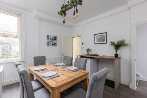 a dining room with a wooden table and chairs at Coastal Escape close to North Bay- Pet Friendly in Scarborough