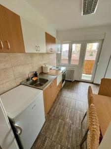 a kitchen with a sink and a counter top at Apartman Nest in Kikinda