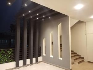 a room with a row of columns on a wall at 3-Beds with Terrace & Amenities in Karachi