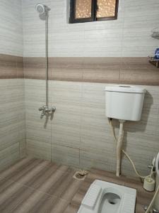 a bathroom with a toilet and a shower at 3-Beds with Terrace & Amenities in Karachi