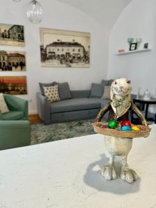 a bowl of easter eggs on a table in a living room at Forst-Ház Apartman in Eger