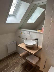ein Badezimmer mit einem Waschbecken und zwei Oberlichtern in der Unterkunft Hotel Auri in Rudník